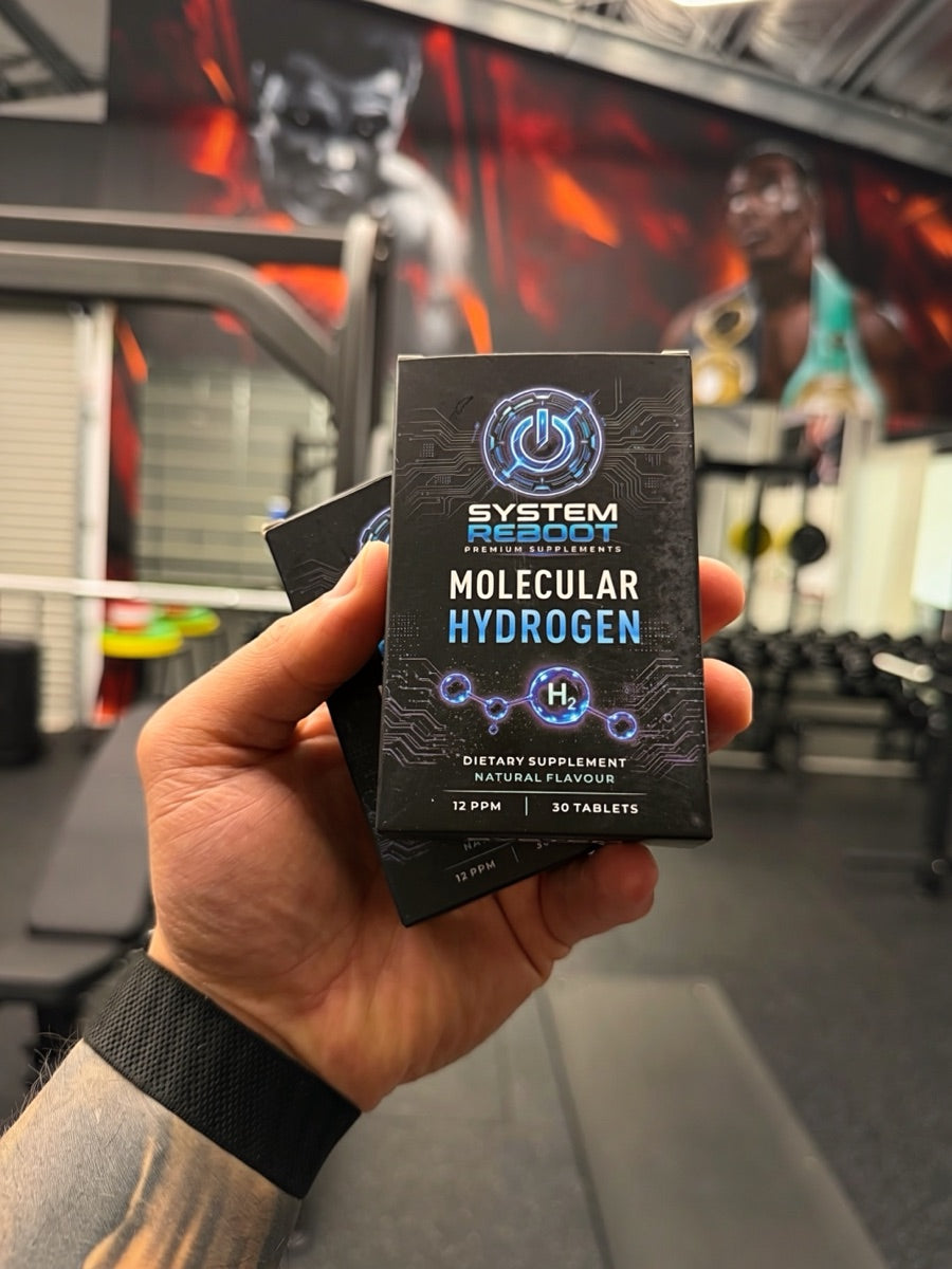 A box of System Reboot Molecular Hydrogen in hand at the gym