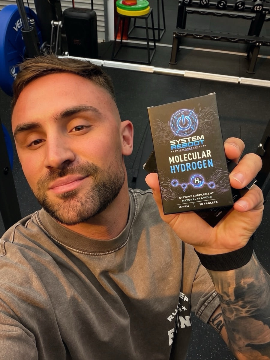 Jackson with a box of System Reboot Molecular Hydrogen at the gym