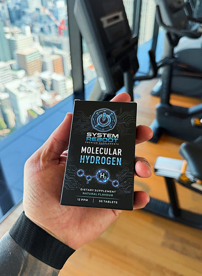 Jackson holding a box of System Reboot Molecular Hydrogen Tablets in the gym