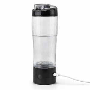 A clear plastic rechargeable hydrogen water bottle with a black base and lid, plugged into a white USB charging cable, on a white background.